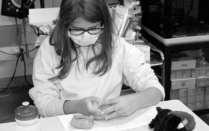 Stacy Van Buskirk/svanbuskirk@cherokeescout.com Addie Luther, a rising fifth-grader at Andrews Middle School, works on the fine details of her pottery face during class on June 24.