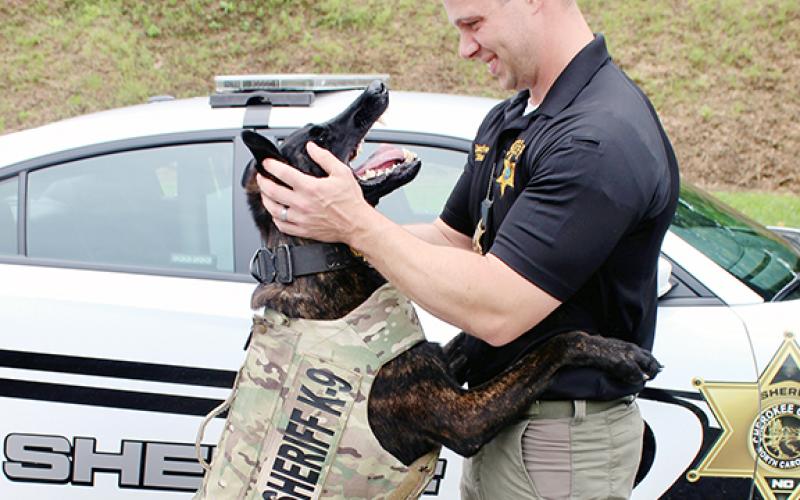 Stiles shares a hug with Bane, who had a 100 percent narcotics detection rate and was responsible for removing a sizeable amount of illegal drugs from Cherokee County streets.