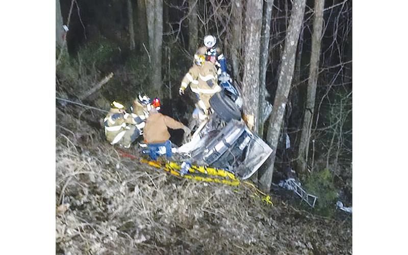 This contributed photo shows rescuers working to save two people from their pickup after it crashed down an embankment off Joe Brown Highway on Feb. 13.