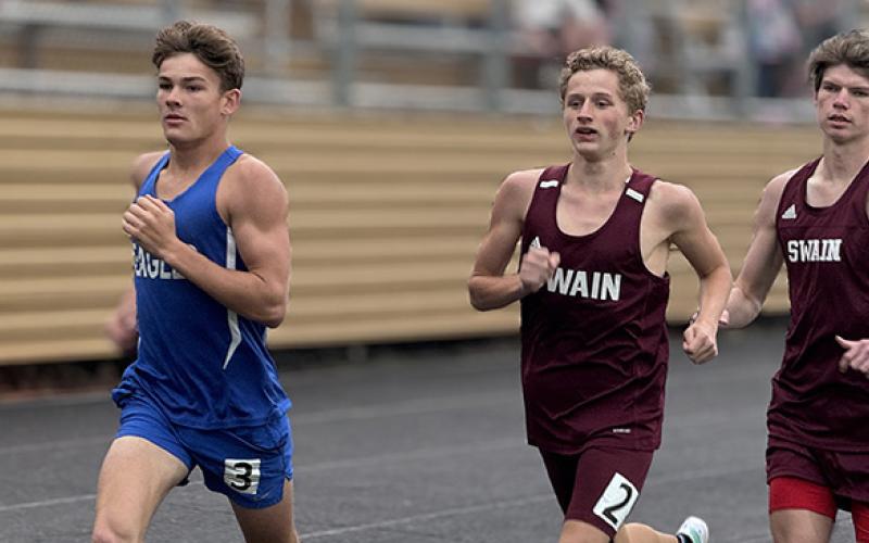J.R. Carroll/Staff Correspondent Hiwassee Dam’s Ethan Russell (left) tries to hold off two Swain County runners during the Hayesville meet on April 17. 