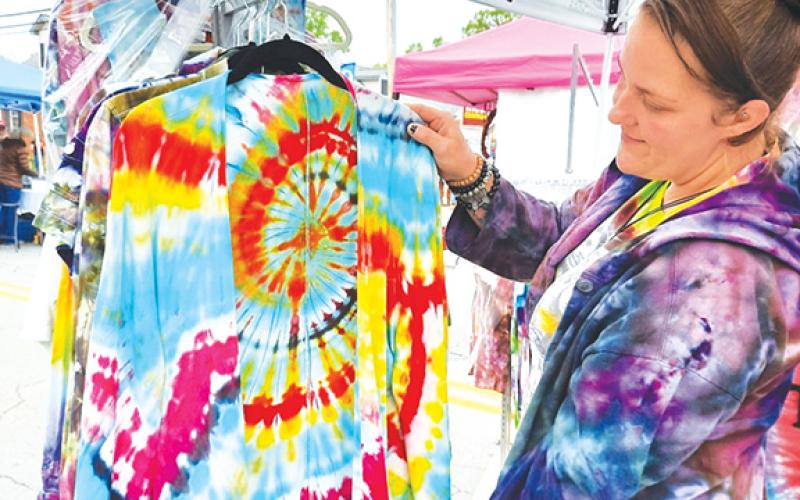 Photos by Anngee Quinones-Belian/Staff Correspondent  Passersby couldn’t miss the colorful clothing on display by Vanessa Miller with Twizted Dyes during the Murphy Spring Festival in May 2022. Her clothing offered eye-catching designs, with no shortage of folks browsing her booth.