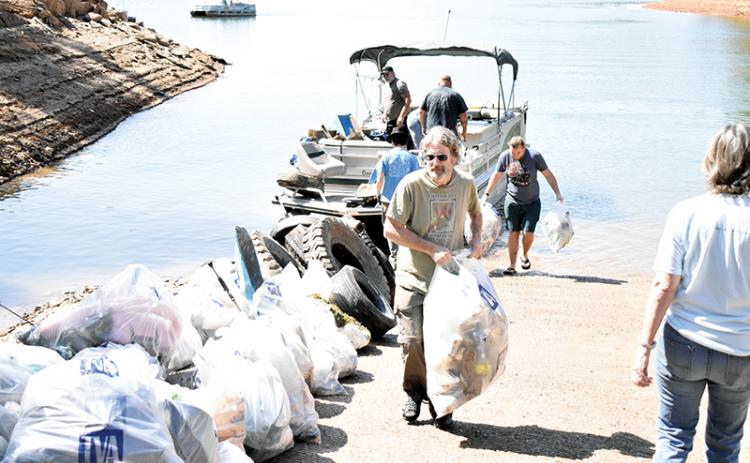 Volunteers pile up bags after pulling mounds of trash from Lake Hiwassee on Saturday during the annual Big Sweep.