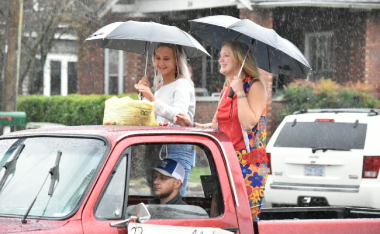Last year's Andrews queens Alyssa Messer and Paige Lindley brave the rain on the back of a truck.