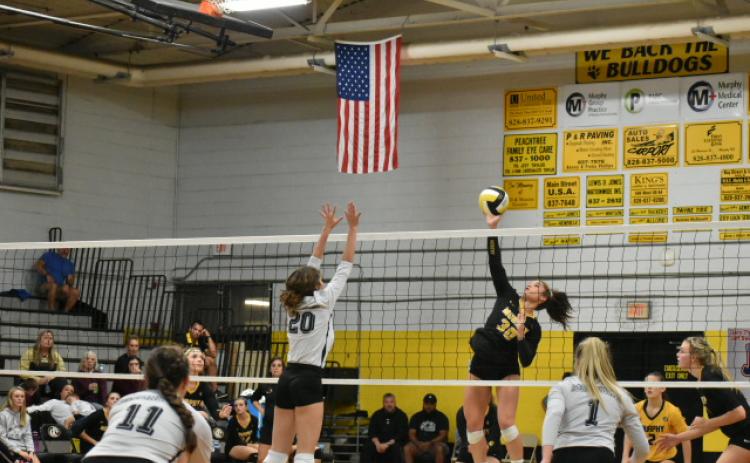 Murphy's Grace Nelson rises for a hit in the SMC Championship match.