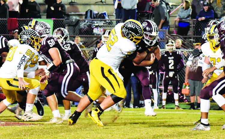 Murphy lineman Colby Stalcup records one of his two sacks Friday night during the Bulldogs’ first win against the Swain Maroon Devils in Bryson City since 2005. Photo by Noah Shatzer