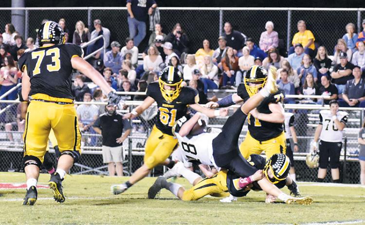 Murphy defenders swarm as linebacker Ray Rathburn upends a Hayesville runner during the Bulldogs’ 62-14 shellacking of the Yellow Jackets on Friday night.