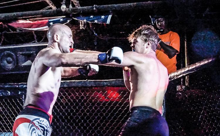 Former Murphy Bulldog Cory Farmer (right) lands a left jab against Gabriel Atkinson in his amatuer Mixed Martial Arts debut with Valor Fighting Challenge on Sept. 6. Photos by Janet Wohler/Valor Fighting Challenge