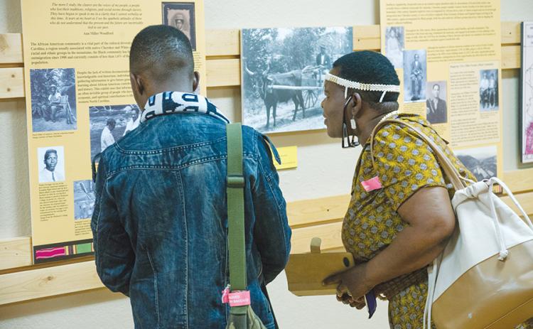 Educators from Botswana - Ipatleleng M. Ntsayakgosi and Ookeditse Johannes - viewed the “When All God’s Children Get Together” exhibit when it first visited the Murphy Art Center in 2017. File photo