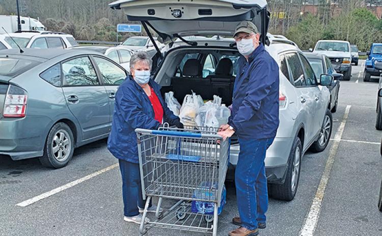 Richard and Mildred Pullium are taking precautions, but like most people still needed to go shopping Thursday. Photo by Sam Jokich