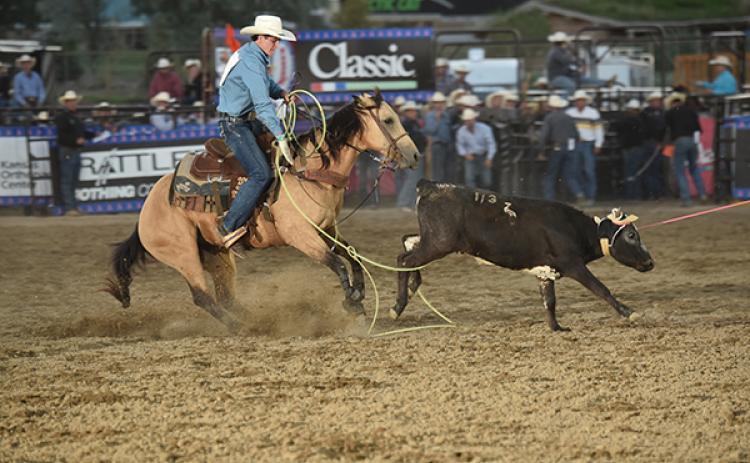 Acentric Rodeo/Contributing Photographer: Marble’s Trevor Boatright ropes the hind legs of an escaping calf during the team roping competition during the National High School Finals rodeo in Guthrie, Okla.  