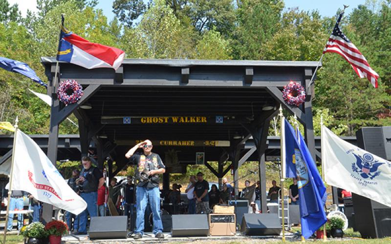 Cherokee County Commissioner Dan Eichenbaum salutes during the playing of “Taps” at the Veterans Educational Appreciation Day event Saturday.