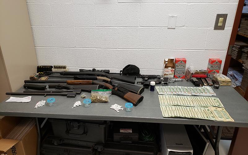 Police seized guns, drugs, cash during an early morning raid in Andrews last week.