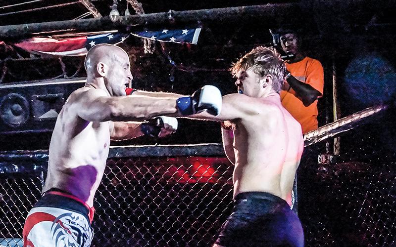 Former Murphy Bulldog Cory Farmer (right) lands a left jab against Gabriel Atkinson in his amatuer Mixed Martial Arts debut with Valor Fighting Challenge on Sept. 6. Photos by Janet Wohler/Valor Fighting Challenge