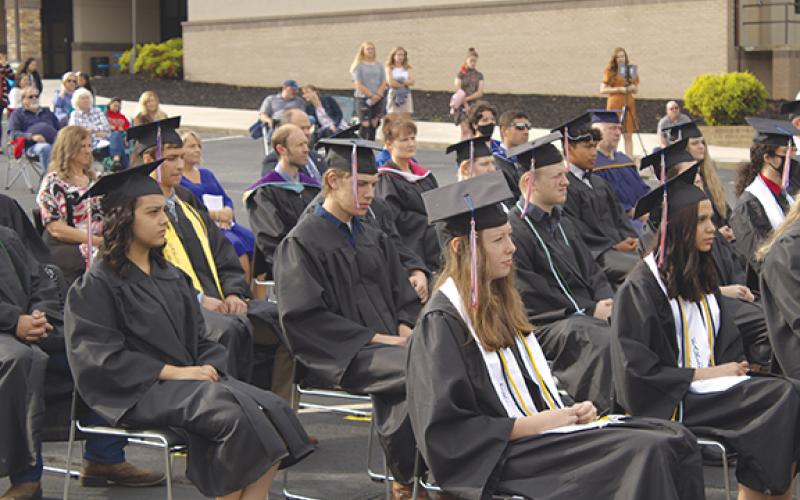 Tri-County Early College High School graduate Sterling Hardin and other graduates return to their seats after receiving their diplomas at the school’s commencement ceremony Saturday morning. This year’s Early College class numbered 31 students. 