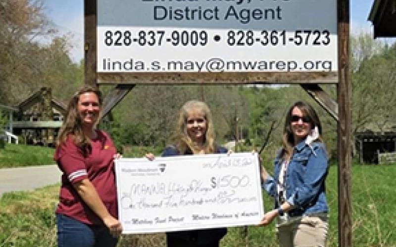 Lynn Hamby (center) and her daughter, Bethany Sharkey of Hiwassee Dam, present a check for $1,500, which she raised by taking the 200-mile challenge for hunger. Whitney Campassi (left) of Asheville is accepting the check for MANNA Food Bank.