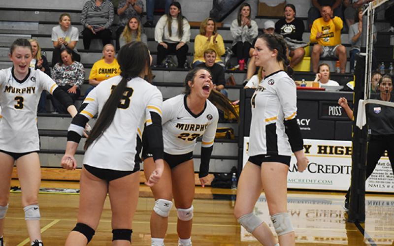 Justin Fitzgerald/sports@cherokeescout.com Murphy's Liv Payne (23) celebrates a point with her teammates during the Lady Bulldogs' four-set win over Alleghany in the second round of the state playoffs Tuesday night.