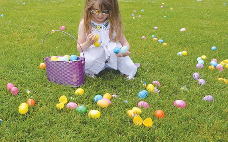 Photos by AbigAil blythe bAtton/Staff Correspondent Four-year old Chris Poe adds a bit of colorful glamour to the annual United Way Easter Egg Hunt & Rubber Ducky Race at Konehete Veterans Park in Murphy on Saturday.