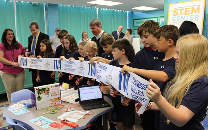 J.R. Carroll/Staff Correspondent Students in Cicely Cable’s STEM Center class at Murphy Elementary School cut the ribbon on April 24 as Cherokee County Board of Education Chair Shannon Raper (far left) and Superintendent Keevin Woody (to her right) look on.