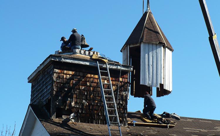 Wally Avett/Cherokee Scout Workers with a crane lifted off the Harshaw Chapel steeple just before Christmas in 2019 and covered the leaking roof with a waterproof plastic film.
