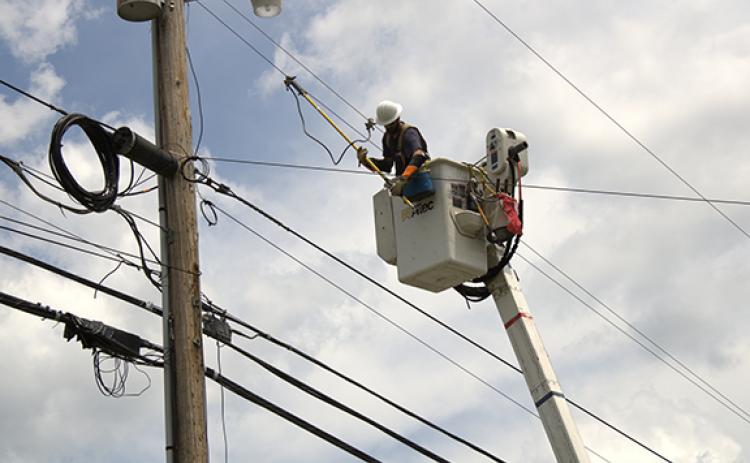 Charlie Benton/cbenton@cherokeescout.com Blue Ridge Mountain Electric Membership Corp. crews work to restore power after several lines fell across U.S. 64 West in Ranger on Friday. 