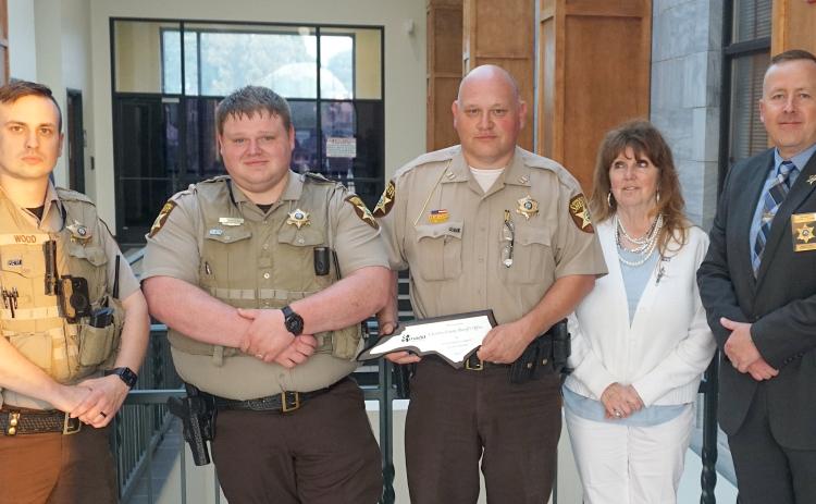 Cherokee County sheriff’s Deputy Hunter Wood, Deputy Dillon Daniels, Capt. David Williams, Ellen Pitt of the Western North Carolina DWI Taskforce and North Carolina Mothers Against Drunk Driving, and Chief Deputy Justin Jacobs (from left) pose following a presentation at the board of commissioners meeting on July 17. Pitt presented a plaque on behalf of MADD for the sheriff's office’s commitment to the safety of the motoring public. The office was recognized for securing training and education of deputies i
