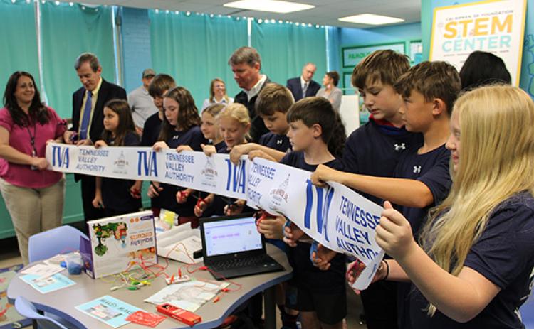 J.R. Carroll/Staff Correspondent Students in Cicely Cable’s STEM Center class at Murphy Elementary School cut the ribbon on April 24 as Cherokee County Board of Education Chair Shannon Raper (far left) and Superintendent Keevin Woody (to her right) look on.