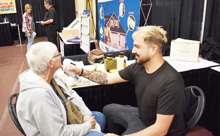 Anngee Quinones-Belian/Staff Correspondent Donna Itterly of Cornelia, Ga., (left) receives a skin smoothing treatment on April 27 from Giovanni, a representative of Spades Cosmetics, during the annual Northeast Georgia Home & Garden Show in Blairsville, Ga.