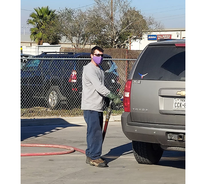 Local driver Allen Crisp fills a Frito-Lay employee’s vehicle in Pharr, Texas.
