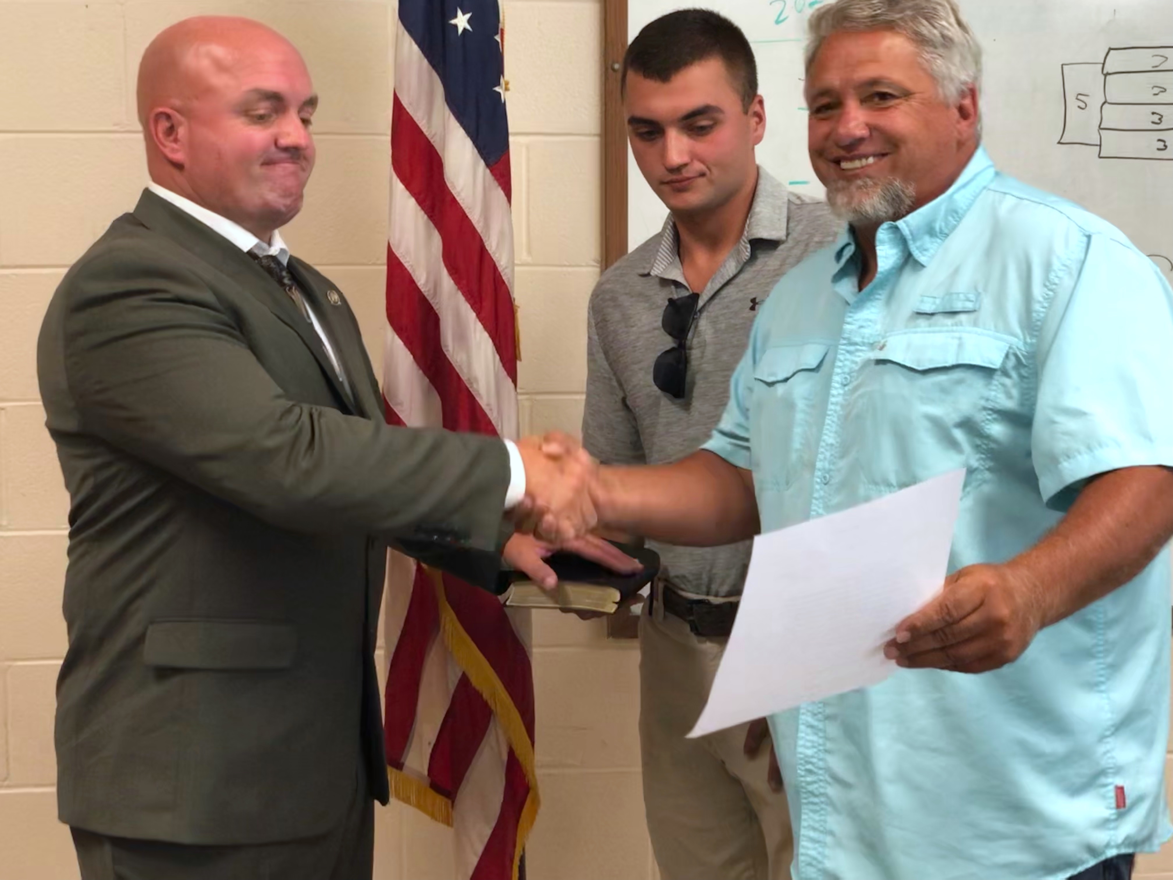Mayor James Reid (far right) congratulates Rocky Burrell on being named Andrews police chief.