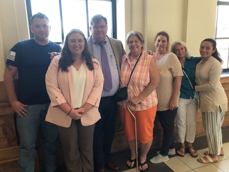 The Bass family (sans James Allen Bass) poses with the defense team following a not guilty verdict last week. From left: James Edward Bass III, legal assistant Becca Thomas, defense attorney Rich Cassady, Mary Jordan, Bobbi Jo Bass, Nancy Perkins and Zulmy Bass.
