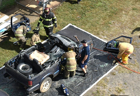 Bill Belian/ Contributing Photographer  Firefighters dismantle a vehicle on Oct. 14 at the Ranger Volunteer Fire Department’s Fire Prevention & Open House event. The demonstration showed the public the department’s different lifesaving techniques while allowing the firefighters to hone their skills.