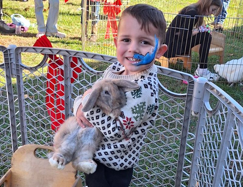 Gianni Nava of Murphy enjoys the petting zoo at the 11th annual Christmas on Main Street on Nov. 23.