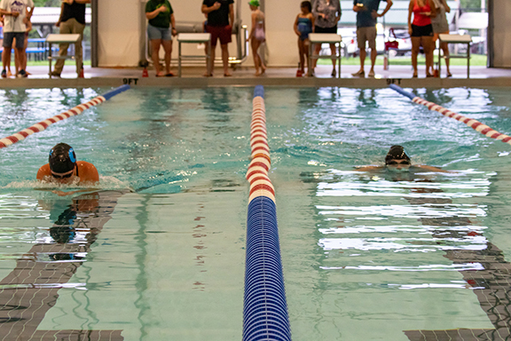 Cannon Crompton/sports@cherokeescout.com Fern Crayton (left) and Sophia Evans compete in the 100-yard breaststroke in Cherokee County Aquatic Club’s home swim meet on July 1. 