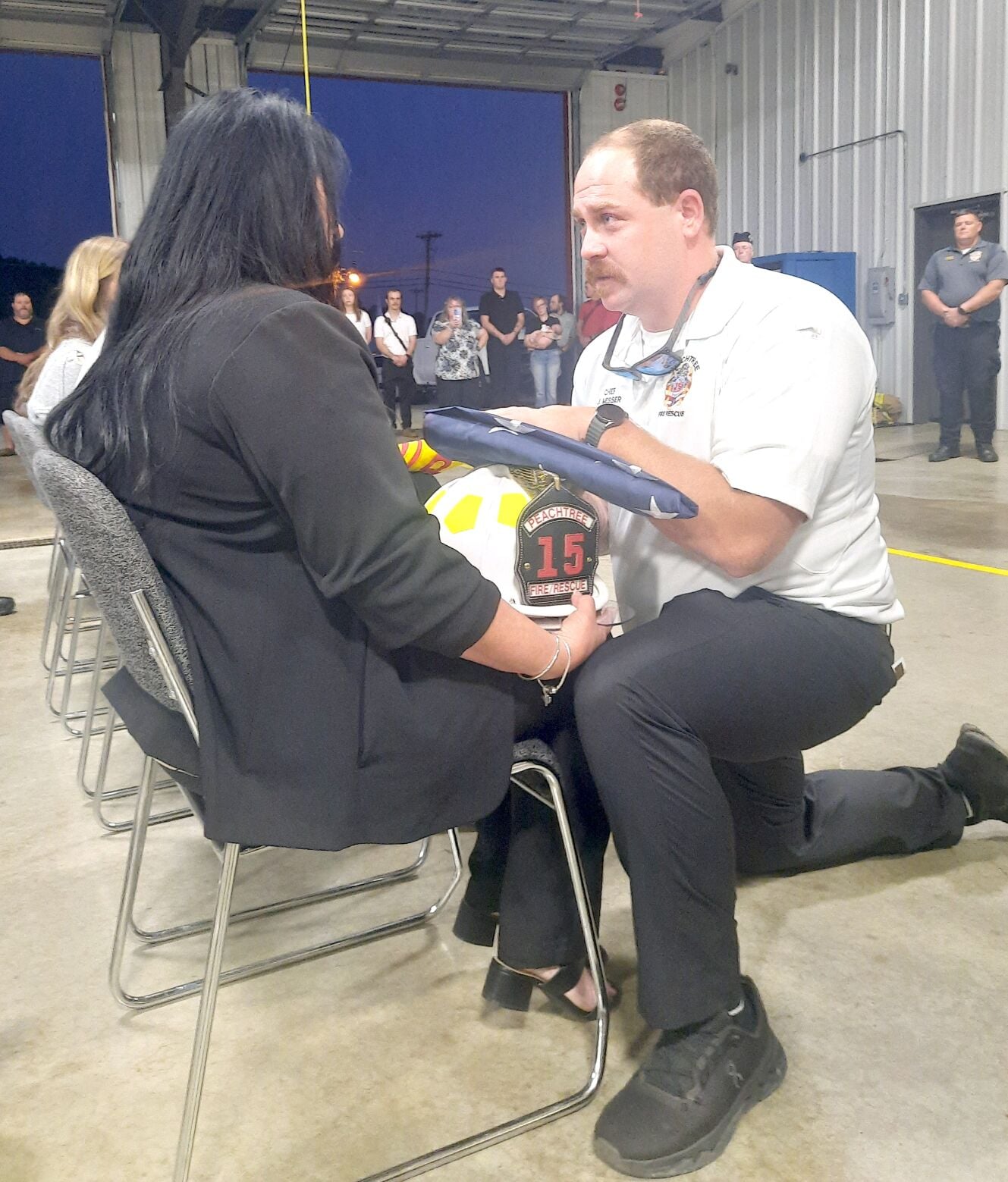 A memorial service was held at Peachtree Fire and Rescue Department for member Alan Andrews, who was previously the Chief of Grape Creek Fire Department. Alan's wife Kim accepts a folded U.S. flag from Peachtree Fire Chief Jordan Messer.
