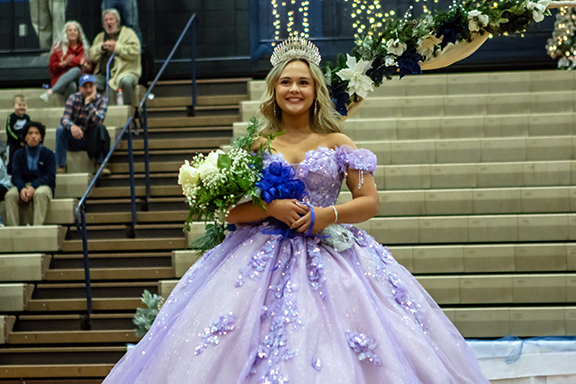 Cannon Crompton/sports@cherokeescout.com The 2024-25 Hiwassee Dam High School homecoming queen, Ally Ledford, smiles after bring presented with a tiara and bouquet of flowers Friday night. Homecoming court, page 12A. Basketball game results, page 1B.