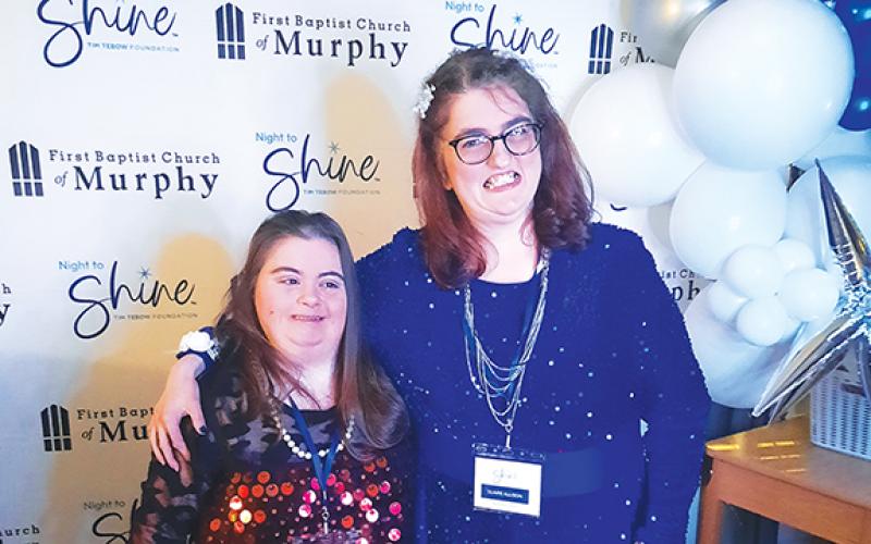 Nicole Casciato and Claire Allison took advantage of the photo booth on-site to remember a special moment in time, at the Night to Shine event on Feb.13.