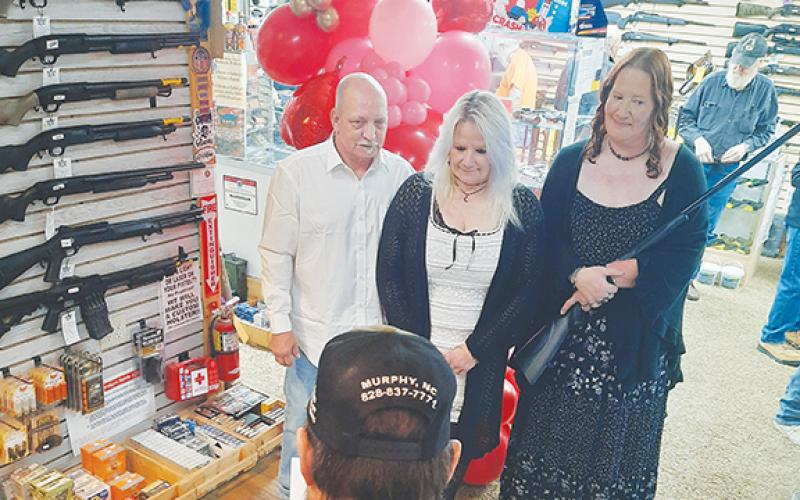 Anngee Quinones-Belian/Staff Correspondent Ernie Sherman and Melissa Wright tied the knot at Cherokee Guns in Murphy on Saturday for Valentine’s Day. Bridesmaid Beth Picklesimer held a free shotgun wedding gift.