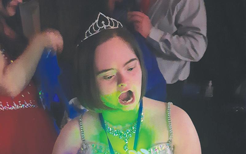 Natalie Meyers enjoyed singing Karaoke at the Night to Shine event on Feb. 13. Glow sticks were also part of the entertainment.