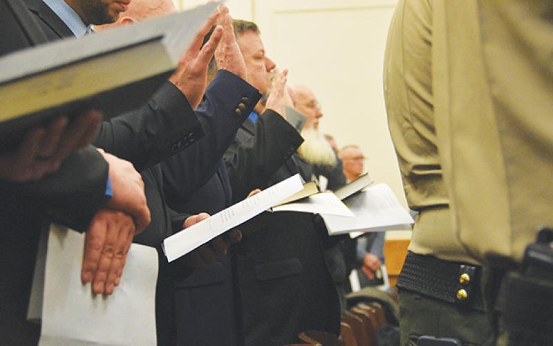 Members of the Cherokee County Sheriff’s Office swear oaths of office administered by Superior Court Judge Tessa Sellers (off screen) at the Cherokee County Courthouse on Monday morning. The sheriff’s office employs more than 80 patrol deputies, investigators, detention officers and staff who were administered oaths at the ceremony.