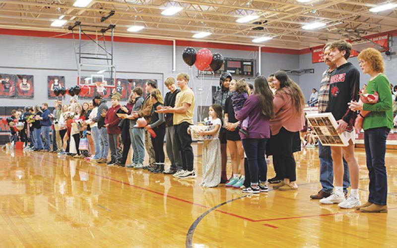 Cannon Crompton/sports@cherokeescout.com Andrews High School honored winter sports student-athletes before Friday night’s basketball games. Joined by their families are seniors (from left) Alexis Beasley, Jaden Crocker, Rileigh LeQuire, Jay C Palmer, Isaac Patrick, Chanteah Rattler and Logan Shuler.