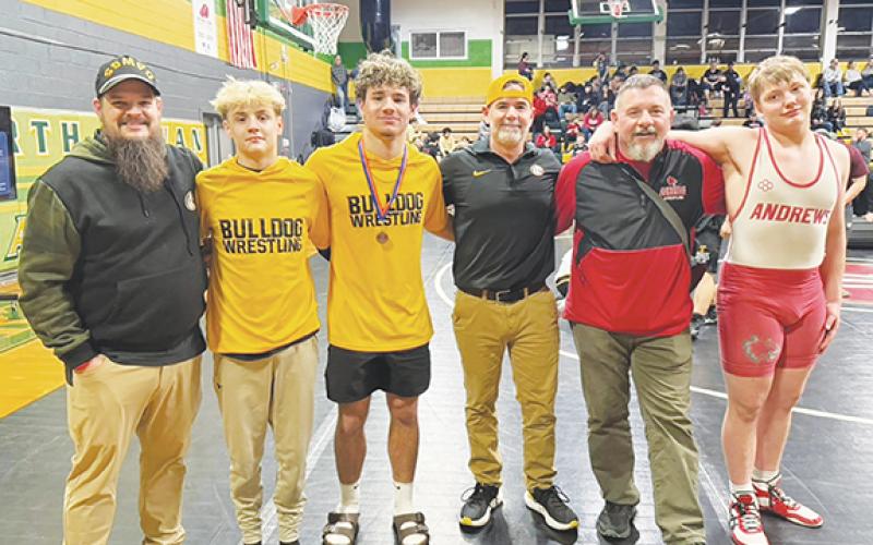 Cheryl Catuto/Contributing Photographer Three athletes from Cherokee County earned a spot in the state tournament with strong performances at the West Regional tournament. From left are Murphy wrestling coach Justin Daugherty, Weston Adams, Anthony Catuto, Murphy wrestling coach Mike Catuto, Andrews wrestling coach Rex Cable and Hayden Virtanen.