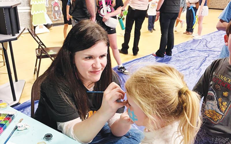 Cicely Cable, MES art teacher, helped run the face-painting booth all night.