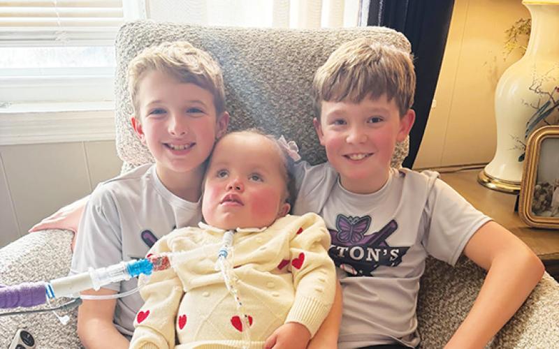 Ralston Hogsed (left) and Mason Lovingood (right) will host the second Home Run Derby to benefit Peyton Mixon (middle) and family, Saturday.