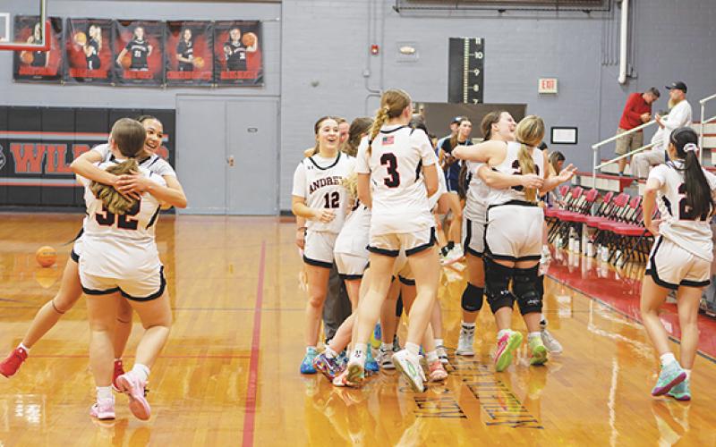 Cannon Crompton/sports@cherokeescout.com The Andrews girls varsity basketball team celebrates its win over Summit Charter on Monday night.