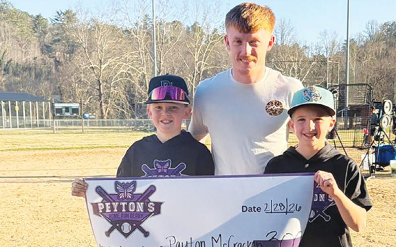 Payton McCracken (middle) celebrates his grand prize winning with Mason Lovingood (left) and Ralston Hogsed (right) before donating funds back to Peyton.