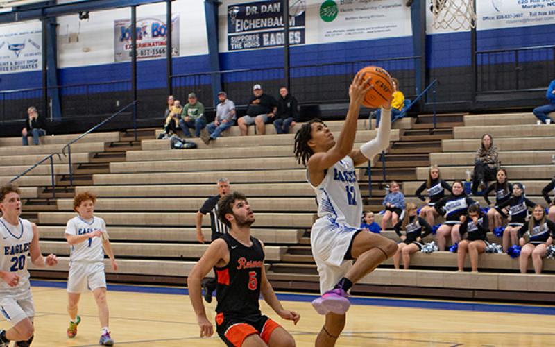 Cannon Crompton/sports@cherokeescout.com Xavier Johnson of Hiwassee Dam goes up for a shot against Rosman on Feb. 24.