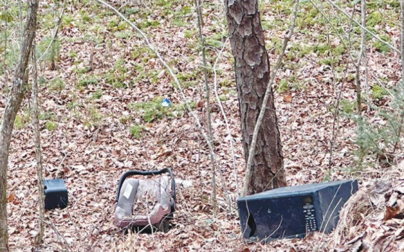 Items such as appliances, televisions, furniture and tires cover the sides of mountains from illegal dumping.