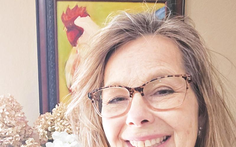 Anngee Quinones-Belian/ Staff Correspondent  Debbie Sanders loves to paint and just hung up one of her paintings, as seen in part behind her.