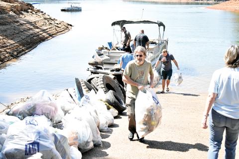 Volunteers pile up bags after pulling mounds of trash from Lake Hiwassee on Saturday during the annual Big Sweep.