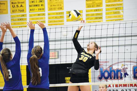 Murphy’s Grace Nelson plays the ball at the net while Hiwassee Dam’s Chloe Roe and Dezeray Adams try to block during a match Sept. 17.